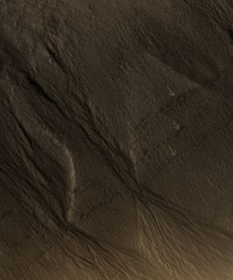 Signs of Fluids and Ice in an Unnamed Crater in Acidalia Planitia (EDM - Absolute Natural Colors; credits for the additional process. and color.: Dr Paolo C. Fienga - Lunexit Team) 
The South-looking (or Equator facing) walls of this Unnamed Crater are cut by numerous Gullies such as the ones shown here (500 x 600 mt or 550 x 650 yards), with well developed Alcoves, sinuous Channels and Terminal Fan Deposits. 
These Gullies seem to originate at the same height, suggesting that the carving agent may have emanated from one single layer exposed in the Crater's Wall.

Contrastingly, no Gullies are observed in the North-looking (or Pole facing) wall of this Crater. Terrestrial Gullies very similar to the ones shown in this image are produced by surface water. 
The arrows in this frame show fissures that may indicate detachment of surficial materials possibly held together by subsurface ice, sliding en masse down the crater's wall.
Parole chiave: Mars from orbit - Craters - Unnamed Crater in Acidalia Planitia