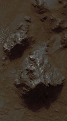 Mojave Crater Floor and Central Uplift (EDM - Natural Colors; credits: Lunexit)
This HiRISE sub-image shows a portion of the Central Uplift structure in Mojave Crater.
Central Uplifts are a typical feature of large impact craters on the Earth, the Moon and Mars; craters larger than 6 or 7 Km in diameter on Mars typically form this mountain-like peak in the central portion of the crater interior.
This peak consists of rocks originating from several kilometers beneath the pre-impact surface. Mojave has a very prominent Central Uplift as it has a diameter of approx. 60 Km (about 37 miles). 
In this image, Boulders as large as 15 mt (50 feet) across have been eroded from the massive uplifted rock and have rolled downslope. 
Fine-grained Debris has also collected in the topographic lows and has been shaped by the wind into Dunes and Ripples. Notably absent from this image are the striking Drainage Channels and Alluvial Fans that are abundant on the Wall-Terraces and Ejecta of Mojave Crater (see PSP_001415_1875). 
These features were likely formed by Surface Runoff of liquid water, which may have been released from the Subsurface during the impact event that formed Mojave.
Previously, it had been suggested that a brief, torrential downpour over Mojave Crater delivered the water. However, Mars Orbiter Camera's (MOC) images of Mojave's Central Uplift have previously shown no evidence for Surface Runoff, and the higher resolution of this HiRISE image (2.4 MB) confirms that this part of the Crater appears untouched by liquid water.

So the question remains: by what means was the water, in the form of Runoff, supplied to Mojave? This question, in addition to several others regarding this phenomenon, are currently being investigated by the HiRISE team and their collaborators.
Parole chiave: Mars from orbit - Craters - Mojave Crater