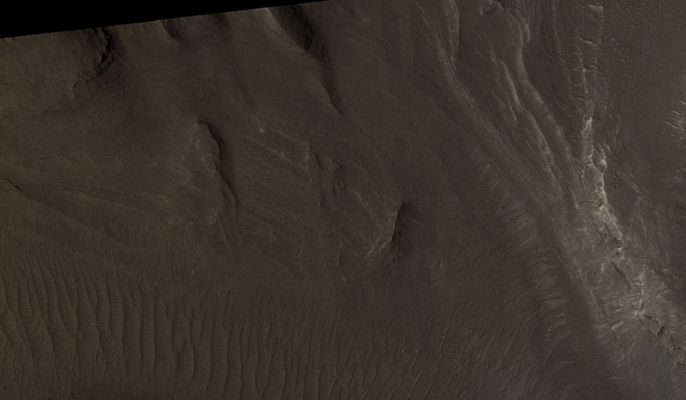 Layered Region in Gale Crater (EDM - Natural Colors; credits: Lunexit)
This EDM shows several Light-Toned Layers. 
The origin of the sediments composing the Layers is unknown and could have included deposition in an ancient flood or lake or the deposition of windblown particles such as Dust or Volcanic Ash. 
The relatively uniform character of the Layers and the manner of erosion suggests that the sediments are fine-grained. 
Parole chiave: Mars from orbit - Craters - Gale Crater