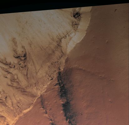 Intersection between Hyblaeus and Elysium Chasmata (EDM n.1 - Saturated Natural Colors; credits for the additional process. and color.: Dr Paolo C. Fienga - Lunexit Team)
A cross-section of Hyblaeus Chasma is visible in this first extra-detail mgnf). 
The chasm seems to be filled with a resistant light-toned layer, about 200 mt thick (likely consisting of cemented windblown sand and dust) forming a mantling unit and overlying more resistant boulder-rich layers. The sand and dust was likely blown into Hyblaeus Chasma after it was formed by tectonic processes, possibly in combination with fluvial processes. 
The chasmata were subsequently broadened by hillslope erosion: boulders are strewn along the top of this dusty mantling unit. Slumping, possibly caused by faulting, along the Southern Wall of Hyblaeus is visible at the intersection with Elysium Chasma.

This image also shows a number of dark streaks along the walls of Elysium Chasma, further to the south.
Parole chiave: Mars from orbit - The Wall of Hyblaeus Chasma