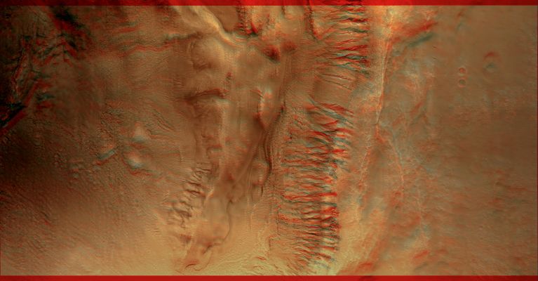 Multiple Levels of Gullies (3D and possible True Colors; credits: NASA and Lunar Explorer Italia)
This image shows groups of gullies at different elevations on the same crater wall. Although gullies are common in the mid-latitudes of Mars, they are rarely found to exist at such distinct elevations as visible here.
The mounds on the floor, one of which contains gullies, probably formed during a late stage of crater formation. Both levels of gullies appear to originate at layers. These layers might be ice-rich, or they might be capable of conducting water to the surface. The anaglyph image, providing a three-dimensional perspective, reveals the relative depth of the gullies in the crater walls and amount of alluvial material deposited at the bottom of the gullies. 
The gullies visible here are good candidates for formation by subsurface water, as opposed to melting ice or snow originating on the surface. The rounded, theater-shaped alcove and tributary heads are typical of features formed by groundwater sapping on Earth. Surface runoff does not form this morphology. 

This image contains possible evidence of subsurface piping, when soil pores connect to form a "pipe" that transports water. When piping occurs, water carries soil with it, leaving empty space beneath the surface. As this process continues, the overlying surface can no longer support itself, and it collapses to form a depression. Several depressions that could have formed this way are seen in this image. The depressions are also directly upslope of more developed alcoves. They also originate at upslope layers, and might be examples of developing alcoves.

Mars Local Time: 15:21 (early afternoon)
Coord. (centered): 37,9° South Lat. and 169,6° East Long.
Spacecraft altitude: 268,5 Km (such as about 167,8 miles) 
Original image scale range: 26,9 cm/pixel (with 1 x 1 binning) so objects ~81 cm across are resolved 
Map projected scale: 25 cm/pixel 
Map projection: EQUIRECTANGULAR 
Emission Angle: 20,6° 
Phase Angle: 24,7°
Solar Incidence Angle: 45° (meaning that the Sun is about 45° above the Local Horizon)
Solar Longitude: 255,0° (Northern Autumn)
Credits: NASA/JPL/University of Arizona
Additional process. and coloring: Lunar Explorer Italia
Parole chiave: Mars from orbit - Gullies - Southern Mid-Latitudes