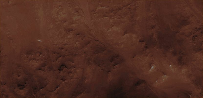 Features of Holden Crater's Rim (CTX Frame "A" - Absolute Natural Colors; credits for the additional process. and color.: Dr Paolo C. Fienga - Lunexit Team)
HiRISE image PSP_004277_1530 covers a portion of the rim of Holden Crater, revealing breaches created when water over-topped the Rim and incised a series of Channels as it flowed down the Crater Wall. 
The water responsible for the Channels was impounded outside of the rim of Holden in Uzboi Vallis (Holden Crater itself is approx. 150 Km in diameter).

Uzboi Vallis was interrupted when Holden Crater formed and the Rim formed an effective, temporary damn to flow farther to the North. Once the Uzboi Basin filled, water began flowing into Holden again, creating a series of low fan-shaped Deltas, alluvial deposits and a shallow, but relatively short-lived lake. 

The Channels in this image were only active for a short time, as a Channel just to the East cut quickly into the Rim and became responsible for most of the drainage into the Crater. 
The fact that most of the fan-shaped Deltas radiate from the Dominant Channel to the East rather than those in this image supports this scenario. 
Parole chiave: Mars from orbit - Craters - Holden Crater