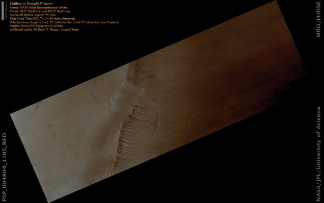 Gullies in Sisyphi Planum (Absolute Natural Colors; credits for the additional process. and color.: Dr Paolo C. Fienga - Lunexit Team)
Image PSP_004804_1105 shows the Walls of a large Pit inside Lyell Crater, near the South Polar Region.

This image was acquired during a period of elevated Atmospheric Dust, following a series of Dust Storms that encircled the Planet; this is the cause of the longitudinal bands of contrasting gray levels in the image. We can still see through the thick Atmosphere, though, Gullies and other subtle features which could have been produced by water and ice present at or near the Surface.

The otherwise subdued Surface in this Region is criss-crossed by numerous fissures, forming Polygons some 10 mt (9 yards) across. Similar features in both shape and scale can be found in terrestrial Periglacial Regions such as Antarctica, where ice is present at or near the Surface. Antarctica's features are the product of repeated expansion and contraction of the soil-ice mixture due to seasonal temperature oscillations. This results in Polygonal Networks of Stress Fractures. 
Parole chiave: Mars from orbit - Sisyphi Planum Region