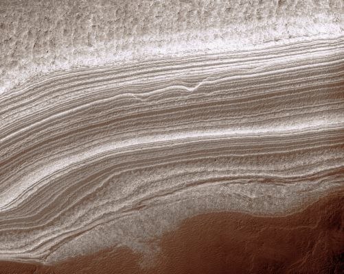 Complex Geology in the South Polar Layered Deposits (extra-detail mgnf)
Above and right of center, the layers appear wavy and in places, layers are cut off by other layers. Such structures may be formed by flow or faulting, but in this case they are more likely to be due to erosion of the lower part of the layered deposits before the upper part was laid down over it. For example, deposition may have halted long enough for channels to be eroded into the layered deposits. 
When deposition resumes, new layers deposited in the channels could form the structures visible here. However, without more precise topographic information than is currently available, other hypotheses cannot be excluded.
Parole chiave: Mars from orbit - South Polar Layered Deposits
