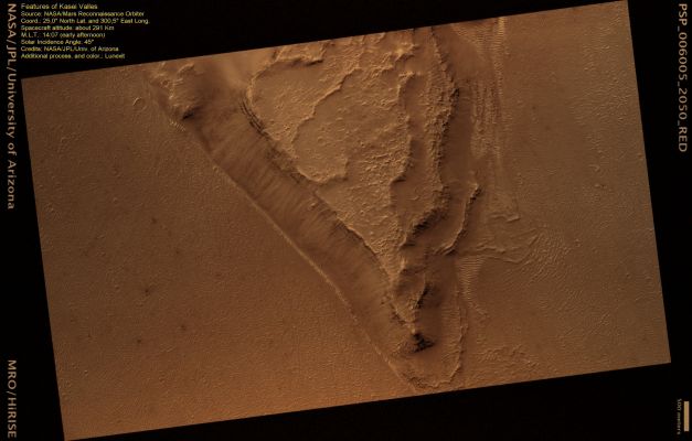 Streamlined Island in Kasei Valles (Saturated Natural Colors; credits for the additional process. and color.: Dr Paolo C. Fienga - Lunexit Team)
In this picture there is a Streamlined Island: one of many observed in the large outflow channels on Mars. This outflow channel is called Kasei Valles, and is one of the largest catastrophic outflow channels on Mars. 
The Streamlined Island forms as water flows through the channel, but is blocked by some sort of obstacle, such as a crater or other topographic landform. In this HiRISE image, we only see the very tail end of the Streamlined Island, which is over 118 Km in length. 
The platy surface within the channels has been attributed to either later lava or mud flows along the surface. The island itself is quite dusty and covered in small craters, so the island may be quite old. Along the edge of the island, however, you can see individual layers of rock. 
These layers represent individual rock units that may be volcanic or sedimentary in origin.
Parole chiave: Mars from orbit - Channels - Kasei Valles Channel System