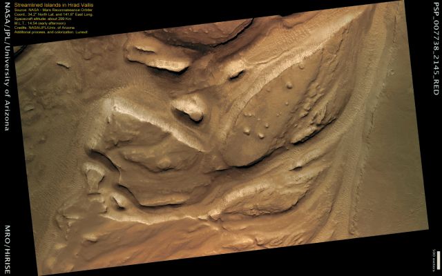 Streamlined Islands in Hrad Vallis (possible natural colors; credits: Lunexit)
This image shows a portion of Hrad Vallis, an approx. 400 mt (1300 feet) deep and about 800 Km (approx. 500 mile) long depression located in the Elysium Planitia.

Hrad Vallis is one of several channel systems that are found just West of the Elysium volcanoes. The scoured floor of Hrad Vallis shows the effects of erosion, presumably by water. 
Flowing water in the past has carved and sculpted rocky masses into streamlined shapes or islands. The streamlined islands often have sharp edges and are narrower at the downstream end and wider at the upstream end. The streamlined islands visible here are located in an area where the flow condensed from the fractured terrain of the Hrad Valles headwaters (to the South-East) to a more regular channel (to the North-West).
Parole chiave: Mars from orbit - Hrad Vallis Region