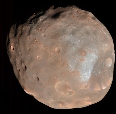 Phobos (Natural Colors; credits: NASA)
HiRISE acquired 2 dramatic views of the Martian moon, Phobos, on 23 March 2008. Observation PSP_007769_9010, acquired at a distance of 6800 Km from Phobos, provides surface detail at 6,8 mt/pixel scale and a object diameter of about 3200 pixels. 
The second observation, PSP_007769_9015, providing a closer look at 5800 Km, views the surface at slightly more detail (5,8 mt/pixel with an object diameter of about 4000 pixels). 
The 2 images were taken within 10' of each other and show roughly the same features, but from a different angle so that they can be combined to yield a stereo view.

The illuminated part of Phobos visible in the images is about 21 Km across. Images from previous spacecraft have been of smaller pixel scale (for example, Mars Global Surveyor got data at 4 mt/pixel, because this spacecraft came closer to Phobos), but the HiRISE images have greater signal-to-noise, making the new data some of the best ever for Phobos.
Parole chiave: Mars' Moons - Phobos