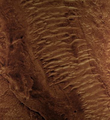 Channels in Jezero Crater Delta (extra-detail mgnf - MULTISPECTRUM; credits: Lunexit)
This extra-detail mgnf shows a section of one channel in greater detail. Wind-blown dunes or ripples now cover much of the channel floor, but in some places the older channel floor is visible. Here, the channel bed has a layered appearance. The plains outside the channel are fractured into polygonal patterns. 
The CRISM instrument has detected water-bearing clay minerals in these plains, which were eroded by flows down the channel. 
Clays are also seen in the sediments deposited on the floor of Jezero Crater.
Parole chiave: Mars from orbit - Channels - Jezero Crater