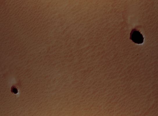 Martian Caves (edm n. 1 - possible natural colors; credits: Lunexit)
The pair of Pit Craters visible here are the smallest “anomalous” pits known to exist at this time. These have either vertical or sub-vertical interior walls (sub-vertical means that they are not visible from a nearly overhead viewing perspective), and each pit is deep enough that sunlight does not hit the floor when the Sun is at or near the Zenith. 

Unfortunately, the only thermal-infrared camera currently orbiting Mars cannot resolve features this small, so the temperature characteristics of these pits must remain unknown for now, underscoring the need for a high-resolution thermal instrument on future missions. 

Intriguingly, when pit craters on Earth have similar characteristics to the pair shown here, they often have cave entrances in their bases connecting to large underground networks. Current investigations are determining whether the anomalous Martian Pits may be shown to contain such entrances.
Parole chiave: Mars from orbit - Collapse Pit - Peri-equatorial Region