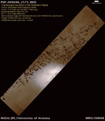 Dunes and Translucent Ice-Spot in the Northern Plains (Saturated and Enhanced Natural Colors; credits for the additional process. and color.: Dr Paolo C. Fienga - Lunexit Team) 
This Terrain is located near the North Pole. The bright patch of material is ice, which might have been deposited in the previous Winter.
After ice in the form of surface frost is deposited from the Atmosphere, it experiences changes throughout the Martian Year. Some of the ice has a polygonal texture which probably formed when temperature variations created stress and cracks in the ice.

The dark features scattered throughout the scene are Dunes. The streaks emanating from the Dunes trending in the South/West direction indicate the dominant direction of the wind in recent times.
Parole chiave: Mars from orbit - Northern Plains - Dunes and Translucent Ice-Spot