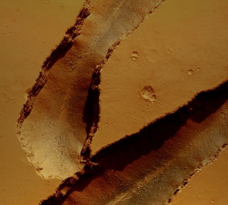 Fissures in Cerberus Fossae (Enhanced and Saturated Natural Colors; credits: Lunexit)
The colors in this frame result from differences in composition of the materials and ALSO  represent how the landscape would appear to the human eye. Note that one can make out boulders and small dunes at the bottom of these fractures and layering within the walls. Just visible at the top of the image is some well-preserved impact crater ejecta. 
The image is 1,2 Km across.
Parole chiave: Mars from orbit - Fissures and Fractures - Cerberus Fossae Region