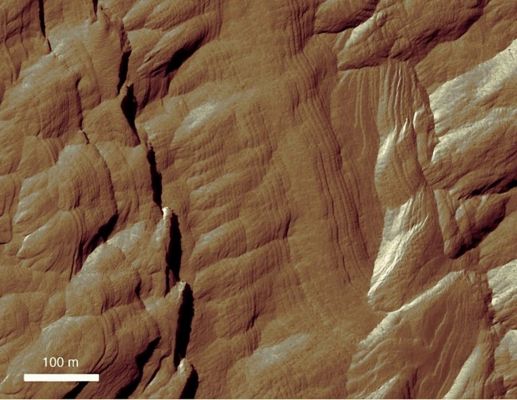 Exposed Layers in Gale Crater (EDM- Enhanced Natural Colors; credits: Lunexit)
This edm is a small portion of a HiRISE image detailing the fine-scale layering evident in the upper mound. The layered deposits can be divided into 2 types: a lower mound with near-horizontal, flat layers, and an upper mound with more numerous, thinner layers (some of which have greater degree of tilt than the lower layers).

The origin of these thin, repetitive layers is unknown, but they likely reflect environmental changes that occurred while the layers were being deposited. 

Today, erosion by wind scour has shaped them into the stair-step pattern that is reminiscent of parts of the American South-West.
Parole chiave: Mars from orbit - Craters - Gale Crater