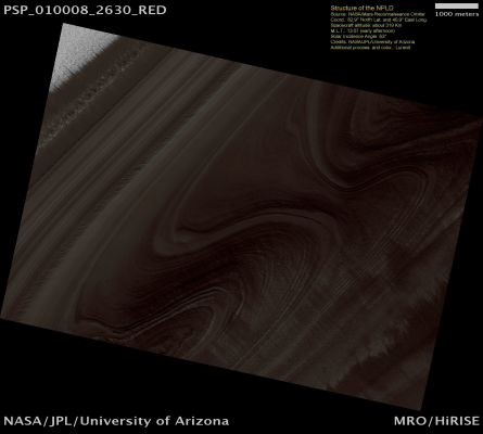 Structure of the North Polar Layered Deposits (natural colors; credits: Lunexit)
This image shows an exposure of the North Polar Layered Deposits (NPLD) within the Northern Residual Ice Cap. The NPLD are thought to have been formed by recent climate changes on Mars, like ice ages on Earth. 

Scientists are studying the NPLD to learn more about these climate changes on Mars. In many places, the NPLD layers appear to extend over large areas, suggesting that they were deposited from atmospheric suspension. If the layers in this image are horizontal and continuous, the apparent curves are caused by erosion of valleys into the NPLD. To determine whether this is the case, HiRISE has acquired two images of this location to form a stereo pair. Analysis of this stereo pair will allow the orientation and thickness of the layers to be measured across the region of stereo coverage, constraining hypotheses for their formation.

Also visible in this image are bright and dark streaks that may be caused by the redistribution of frost by winds.
Parole chiave: Mars from orbit - North Polar Regions - NPLD