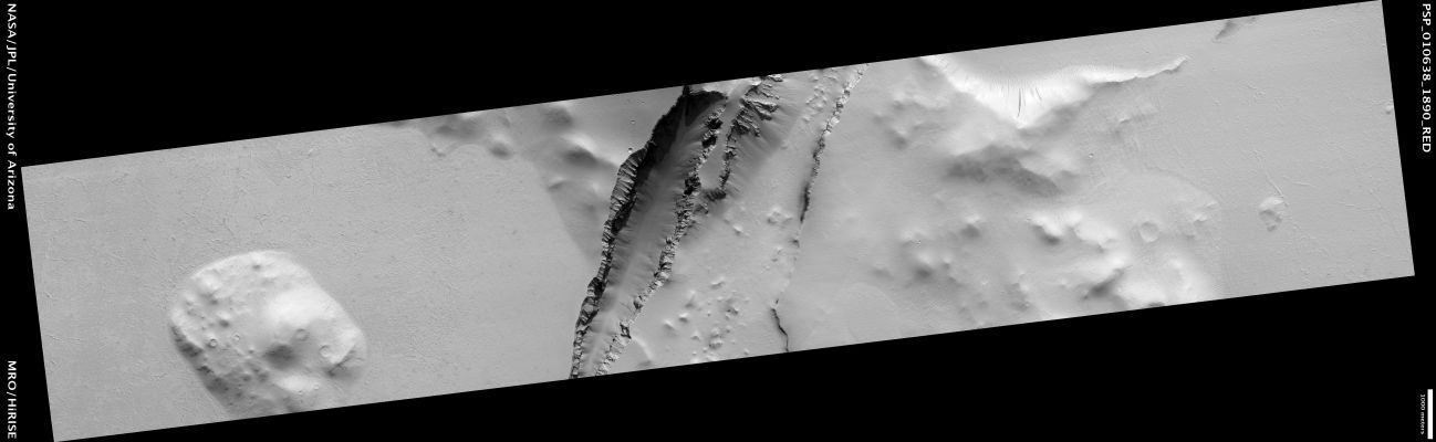 Angular Unconformity in Cerberus Fossae (ctx RAW frame)
This HiRISE image shows a part of the Cerberus Fossae, a long system of aligned fissures. The Cerberus Fossae were the source of the youngest major volcanic eruption on Mars that covered much of the surrounding area in lava. The region has also seen much other volcanic activity. 

The walls of the fissures typically reveal lava layers. At this site, they have cut through an older hill that protrudes above the surrounding plains. The layers within the hill are tilted relative to the overlying rock, which appears to drape the region and runs continuously over the hill and plains. 

This tilted contact is known as an Angular Unconformity. It is most likely that this formed when horizontal layers were tilted by faults before the most recent volcanic eruptions, forming the irregular hills. 
The hills represent relatively old rock, while the smooth plains and the thin draping cover were formed more recently.
Parole chiave: Mars from orbit - Cerberus Fossae Region