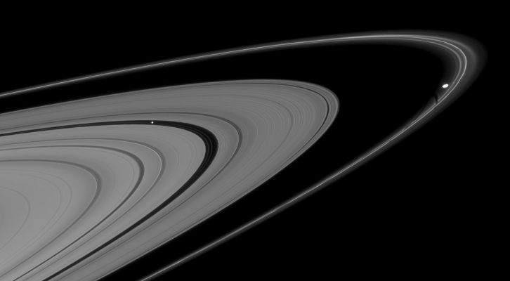 Gravitational Disturbances
Caption NASA:"This mosaic of two Cassini images shows Pan and Prometheus creating features in nearby Rings. 
Pan (approx. 28 Km, or about 17 miles across), in the Encke Gap at left, is trailed by a series of edge waves in the outer boundary of the gap. Prometheus (approx. 86 Km, or about 53 miles across at its widest point) just touches the inner edge of Saturn's F-Ring at right, and is followed by a series of dark channels in the Ring, which were caused by the passage of Prometheus through the F-Ring on previous orbits. 

This view looks toward the unilluminated side of the rings from about 3° above the Ring-Plane. The images were taken in visible light with the Cassini Spacecraft narrow-angle camera on Aug. 15, 2008. The view was obtained at a distance of approx. 1,2 MKM (746.000 miles) from Pan and Prometheus. 
Image scale is roughly 7 Km (about 5 miles) per pixel on both moons".
Parole chiave: Saturn's Rings - Pan and Prometheus