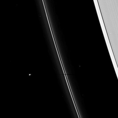 Pandora
Caption NASA:"The thin shadow of the moon Pandora cuts across Saturn's narrow F-Ring. 
As Saturn approaches its August 2009 Equinox, the planet's moons cast shadows onto the Rings. Pandora (about 81 Km, or approx. 50 miles across) is on the left of the image. Other bright points of light in the image are background stars. 

This view looks toward the unilluminated side of the Rings from about 55° above the Ring-Plane. The image was taken in Visible Light with the Cassini Spacecraft narrow-angle camera on April 16, 2009. The view was obtained at a distance of approx. 1,3 MKM (such as about 808.000 miles) from Saturn and at a Sun-Saturn-Spacecraft, or Phase, Angle of 98°. 
Image scale is roughly 8 Km (about 5 miles) per pixel".
Parole chiave: Saturn's Moon - Pandora