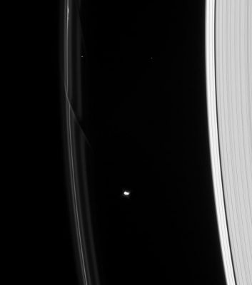The "visual meaning" of Gravity
Caption NASA:"Two dark gores in Saturn's F-Ring demonstrate the gravitational influence of the shepherd moon Prometheus. 
The older gore at the top of this view is at a steeper angle than the newer addition just above and to the left of Prometheus, since the former has sheared out over the course of an orbit: particles on the inner (right) side of the F-Ring travel faster in the same amount of time than the particles on the outer (left) side, leaving the outer particles behind. Prometheus (102 Km, or about 63 miles across) is lit at left by direct sunlight and at right by reflected light from Saturn. The bright, sunlit portion of the moon is overexposed. 
Two background stars are captured above Prometheus in this view, which looks toward the unilluminated side of the Rings from about 33° above the Ring-Plane. 

The image was taken in visible light with the Cassini spacecraft narrow-angle camera on Jan. 1, 2008. The view was acquired at a distance of approx. 1,5 MKM (such as Rabout 956.000 miles from Saturn and at a Sun-Saturn-spacecraft, or phase, angle of 62°. 
Image scale is roughly 9 Km (approx. 6 miles) per pixel". 

Parole chiave: Saturn's Moons - Prometheus