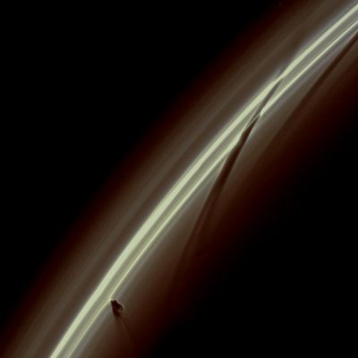 Streamer Channel (Natural Colors; credits: Lunar Explorer Italia)
Caption NASA:"Half an hour after Prometheus tore into this region of Saturn's F -Ring, the Cassini Spacecraft snapped this image just as the moon was creating a new Streamer in the Ring. The dark pattern shaped like an upside down check mark in the lower left of the image is Prometheus and its shadow. 
The potato shaped moon can just be seen coming back out of the Ring. The moon's handiwork also is apparent in 2 previous Streamer-Channel formations on the right of the image. The darkest Streamer-Channel stretching from the top right to the center of the image shows Prometheus' previous apoapse passage about 15 hours earlier. A fainter, even earlier channel extends to the edge of the image. 
Prometheus (about 86 Km, or approx. 53 miles across) dips into the inner edge of the F-Ring when it reaches apoapse, the moon's farthest orbital point from Saturn. At apoapse, the moon's gravity pulls particles of the ring outward into a streamer. 
As Prometheus moves onward toward periapse — its orbit's closest point to the Planet — the Streamer gets longer. Then, as Prometheus moves back toward apoapse, the Streamer breaks apart which results in a dark channel. 

This Streamer-Channel cycle repeats once every orbit with the Streamer-Channel features being streamers during Prometheus periapse and channels during Prometheus apoapse. The F-Ring is overexposed in this image which has been brightened to reveal the moon. 

This view looks toward the unilluminated side of the Rings from about 18° above the Ring-Plane. The image was taken in Visible Light with the Cassini Spacecraft narrow-angle camera on Jan. 14, 2009. 
The view was obtained at a distance of approx. 555.000 Km (345.000 miles) from Saturn and at a Sun-Saturn-Spacecraft, or Phase, Angle of 145°. 
Image scale is roughly 3 Km (a little less than 2 miles) per pixel".
Parole chiave: Saturn's Rings - "F" Ring with Prometheus