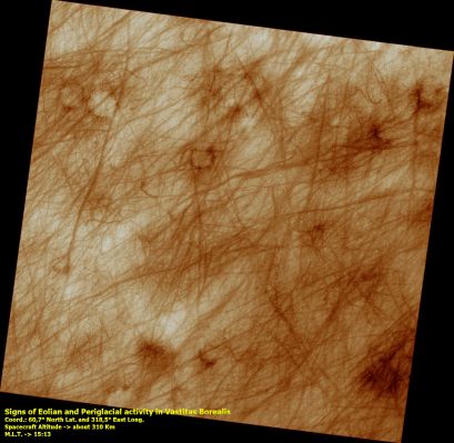 Eolian and Periglacial Activities in Vastitas Borealis (DD Tracks and Polygons)
This image shows a region of approximately 7 x 7 km (4.4-by-4.4 miles) located in Vastitas Borealis, part of the Northern Plains. 

The surface imaged is relatively young, as indicated by the lack of recent impact craters. 
Eolian and Periglacial activity seem to be the dominant geological processes at work, as shown by numerous crisscrossing DD Tracks and ubiquitous polygonal features, respectively.

Dust Devils form when the sun warms up the air near a flat, dry surface. Warm air then rises quickly through the cooler air above and starts spinning, causing a forward motion. The spinning, forward-moving cell may pick up dust and sand as it advances, thus leaving behind a "clean" track. We infer from this image that a thin veneer of light-colored particles of dust and/or fine-grained sand cover relatively darker materials, apparent in the dust devil tracks.

The tracks pictured in this image are in many cases more than 30 mt (27 yards) wide and over 4 Km (2,5 miles) long, surpassing the dimensions of average terrestrial DD tracks.
Parole chiave: Mars from orbit - Vastitas Borealis