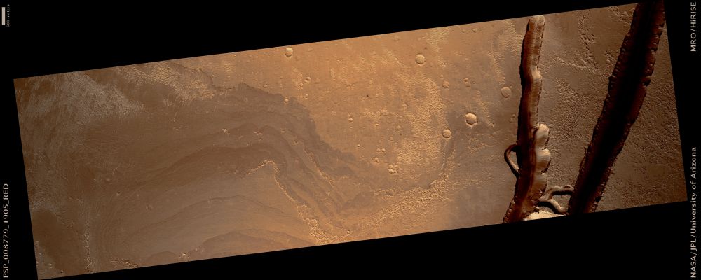 The Head of Athabasca Valles (natural colors; credits: Lunexit)
This observation is located at the head of the Athabasca Valles Channel System, which lies just North of Mars’ Equator, in a low-elevation Region known as Elysium Planitia. 

Athabasca Valles has an interesting geologic history. It was probably carved by one or more catastrophic floods of water, but more recently, a flood of lava coursed through the channel system. Both the water and the lava erupted from a few discrete points (or “vents”) along the Cerberus Fossae, a 1600-Km(1000-mile) long network of extensional (or “normal”) faults. The two prominent troughs that cut across the Southern end of this HiRISE image are part of the Cerberus Fossae. They are distinct fault segments that overlap at their tips, as one tapers in and the other pinches out. 

They were not always as wide as they are today. Erosional processes have widened the troughs over time. Major eruptions occurred along both of the fault segments seen in this image, though they occurred to either side of the imaged area itself. Lava that erupted from the western vent covers the northern half of the image. The lava has raised, lobate margins and is slightly darker in tone than the older cratered plains it embays. The lava also has a banded appearance of subtly contrasting lighter and darker tones, that correspond to variations in surface roughness. 
The bands are concentric to a vent located immediately west of the imaged area. Unfortunately, vents along the Cerberus Fossae are not well preserved.
Parole chiave: Mars from orbit - Trough - Athabasca Valles Region