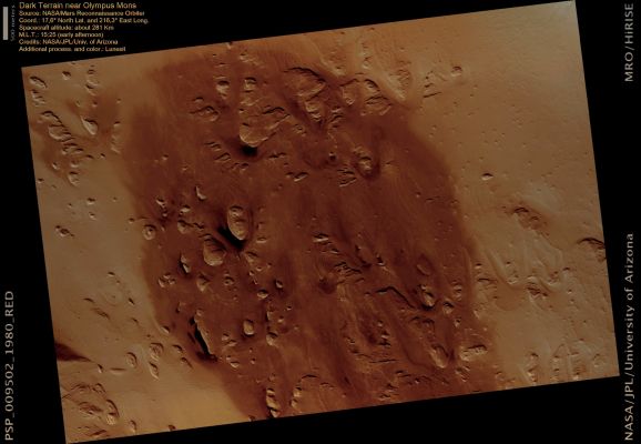 Dark Spot Near Olmpus Mons Volcano (natural colors; credits: Lunexit)
This image covers a relatively dark-toned patch of ground West of the Olympus Mons volcano. This spot is one of several "Dark Areas" in this Region of Mars. 
These Dark Spots are distinctive because much of the surrounding area appears to be covered by light-toned dust. 

In pre-HiRISE images, the origin of this Dark Spot was ambiguous. This HiRISE image reveals that the dark color is likely the result of accumulations of Basaltic Sand (smooth, brown-colored material in this natural color view) on top of otherwise relatively dust-free bedrock.
Evidence of layering is also visible within the dark area. There are alternating bands of lighter- and darker-toned material, consistent with alternating layers of bedrock. These alternating bands are not apparent outside of the Dark Area. This may mean that alternating layers of bedrock only occur within the dark area, or that these bedrock layers occur throughout the region but are covered and obscured by light-toned dust outside of the Dark Area.
Parole chiave: Mars from orbit - Tharsis Region