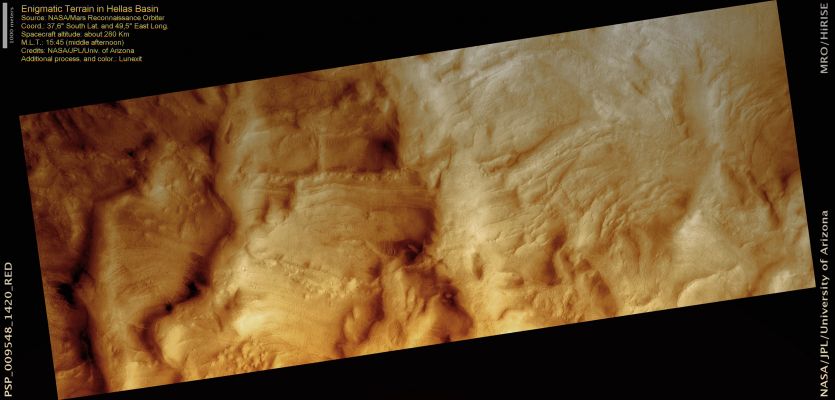 Enigmatic Terrain in Hellas Planitia (Saturated Natural Colors; credits for the additional process. and color.: Dr Paolo C. Fienga - Lunexit Team)
Hellas Planitia is the low-lying plain on the floor of the Hellas Basin, an ancient impact crater over 2000 Km wide. This Basin includes the lowest point on the surface of Mars. 

A variety of unusual landforms occur on the floor of the basin due to the low elevation. One hypothesis is that Hellas may once have held lakes or seas, possibly with thick ice that might account for some of these features. 
This image shows a small portion of Western Hellas, in a Region of "Enigmatic Ridges". 
These ridges form an intricate pattern, enclosing kilometer-wide depressions. These strange features are still not well-understood; one possibility is that they formed in lake-bottom sediments when ice covering the lake touched bottom and shoved wet, loose material to the side. 
This HiRISE image reveals that the ridges contain many boulders; sediments deposited on the bottom of a lake might be fine-grained, although they may have hardened to rock later. The image also shows lineations, probably outcropping layers, running between the large ridges.

Because the resolution of HiRISE images is sufficient to see details such as the abundance of boulders and the presence of thin sedimentary layers, images of this and other poorly-understood terrains will be important in interpreting the geological and climatological history of Mars.

This observation is part of a stereo pair along with PSP_007834_1420.
Parole chiave: Mars from orbit - Hellas Planitia Region