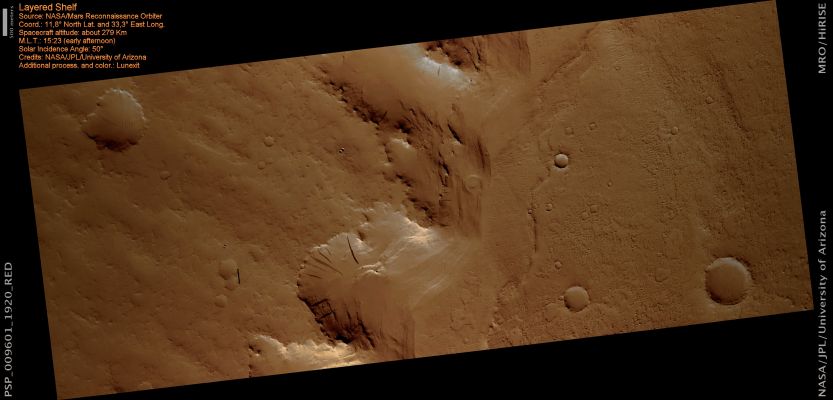 Layered Shelf (possible natural colors; credits: Lunexit)
This image shows the edge of a Layered Shelf in a large Impact Crater. Sediments form a bench with a flat top and steep edge along part of the interior wall. This site shows part of the steep edge of those deposits. 

The bench is formed by an upper layer that is relatively hard and resistant, while lower rocks are soft. Once the upper cap layer is removed, the weaker material below is easily eroded. This structure can be seen here: at the very top of the bench is a relatively steep lip, while material below has a muted appearance. A few steep outcrops lower on the slope suggest that there could be other strong layers. 

Because of pervasive dust cover, it is difficult to learn much about the nature of the rocks here. Dust builds up by settling out after the many large Martian Dust Storms. (The dark streaks running downhill are seen in many dusty parts of Mars and are thought to be traces of dust avalanches). However, some small-scale structures are visible through the dust. Some fine layering is also visible, particularly near the base of the slope. 
The layers are probably still covered by dust, but not enough to completely obscure the underlying structure.
Parole chiave: Mars from orbit - Craters - Unnamed Crater with Layered Shelf