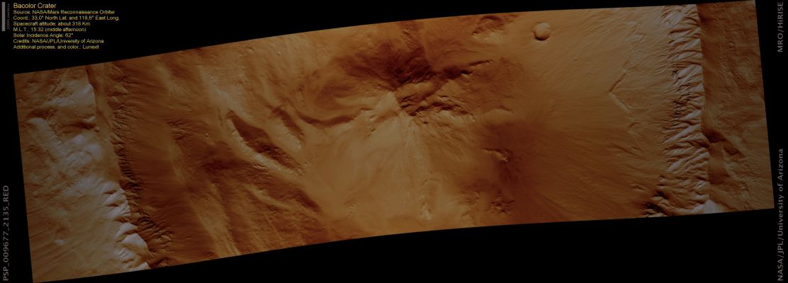 Bacolor Crater (natural colors; credits: Lunexit)
Bacolor Crater is a pristine crater in the Northern Hemisphere. The linear striations visible at both sides (Sx and Dx) of the image are from the blast of the formation impact. This crater has a Central Peak, other mounds and terraces on its floor. 
All of these features appeared during the final stages of crater formation.

The Northern Wall of the crater has landslides which have sculpted the Crater Rim. The Southern Wall has Gullies, thought to form by fluvial processes. 
The Gullies here are more incised (cut into the slope) than the landslides are.
Parole chiave: Mars from orbit - Craters - Bacolor Crater