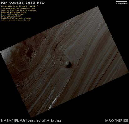 Unusually-looking "Mound" in the NPLD (natural colors; credits: Lunexit)
The North Polar Layered Deposits (NPLD) are composed of a stack of ice-rich layers that is up to several kilometers thick. Each layer is thought to contain information about the climate that existed when it was deposited, so the stack of layers within the NPLD may represent a record of how climate has varied on Mars in the recent past.

We can see these internal layers exposed in the many troughs and scarps that have been cut by erosion into the stack. One of these troughs, visible in this image, contains a 500 meter (1640 feet) thick section of this layering.
However, the layers are not the only interesting thing being shown here. There is a conical mound part-way down the slope that is approximately 40 m (130 ft) high. One possible explanation for this anomaly is that it may be the remnant of a buried impact crater that is now being exhumed. As the NPLD accumulated, impacts occurred throughout its surface which were then buried by additional ice. These buried craters are generally inaccessible to us, but in a few rare locations, erosion that forms a trough (like this one) can uncover these buried structures. For reasons that are poorly understood right now, the ice beneath the site of the crater is more resistant to this erosion, so when material is removed in forming the trough the ice beneath the old impact site remains, creating this isolated hill.

An inspection of the full-resolution data shows that polygonal blocks, up to 10 mt (33 feet) across, make up this mound. Although covered with reddish dust, the blocks resemble ice-rich blocks seen in other exposures of the NPLD.
Parole chiave: Mars from orbit - North Polar Features - NPLD