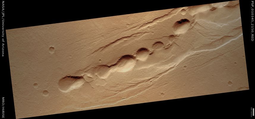Pits in Cyane Fossae (Saturated Natural Colors; credits for the additional process. and color.: Dr Paolo C. Fienga - Lunar Explorer Italia)
Mars Local Time: 15:30 (middle afternoon)
Coord. (centered): 34,4° North Lat. and 239,0° East Long.
Spacecraft altitude: 285,7 Km (such as about 178,6 miles) 
Original image scale range: 57,2 cm/pixel (with 1 x 1 binning) so objects ~1,72 mt across are resolved 
Map projected scale: 50 cm/pixel 
Map projection: EQUIRECTANGULAR 
Emission Angle: 0,3° 
Phase Angle: 50,5°
Solar Incidence Angle: 50° (meaning that the Sun is about 40° above the Local Horizon)
Solar Longitude: 139,8° (Northern Summer)
Credits: NASA/JPL/University of Arizona
Additional process. and coloring: Lunar Explorer Italia
Parole chiave: Mars from orbit - Collapse Features - Pits