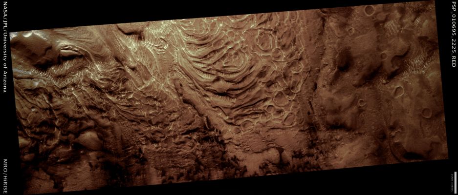 Flow near the Central Peak of Moreux Crater (possible True Colors; credits: Lunar Explorer Italia)
This image is of a flow feature within Moreux Crater, located at about 42° North Lat. and 44,6° East Long.,  on the edge of Mars’ Highlands/Lowlands Boundary. The Crater itself is roughly 135 Km in diameter.

During the impact that forms craters, a roughly bowl shaped volume is excavated from the Martian Crust. In craters larger than about 7 Km in diameter, a Central Peak (or Mound) forms on the floor of the crater. This image focuses on a portion of the Moreux Central Peak that apparently broke off and slid away, forming a type of Giant Landslide. 
Interesting hummocks, swirls and ridges are found on the surface of the Landslide. There are also distinct, almost circular depressions of unknown origin near the foot of the flow. 
Both light and dark toned dunes later formed on this landform.

§§§

Mars Local Time: 15:43 (middle afternoon)
Coord. (centered): 42,0° North Lat. and 44,7° East Long.
Spacecraft altitude: 322,4 Km (such as about 201,5 miles) 
Original image scale range: 32,2 cm/pixel (with 1 x 1 binning) so objects ~97 cm across are resolved 
Map projected scale: 25 cm/pixel
Map projection: EQUIRECTANGULAR 
Emission Angle: 22,5° 
Phase Angle: 35,7°
Solar Incidence Angle: 58° (meaning that the Sun is about 32° above the Local Horizon)
Solar Longitude: 153,6° (Northern Summer)
Credits: NASA/JPL/University of Arizona
Additional process. and coloring: Lunar Explorer Italia
Parole chiave: Mars from orbit - Craters - Moreux rater