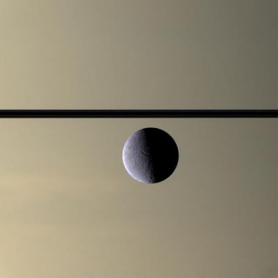Sliding Away... (natural colors; credits: NASA)
Caption NASA:"The Cassini Spacecraft looks toward Rhea's cratered, icy landscape with the dark line of Saturn's Ring-Plane and the Planet's murky atmosphere as a background. 
Rhea is Saturn's second-largest moon, at about 1528 Km (approx. 949 miles) across. 
This view looks toward the unilluminated side of the Rings from less than 1° above the Ring-Plane. 

Images taken using red, green and blue spectral filters were combined to create this natural color view. The images were acquired with the Cassini spacecraft narrow-angle camera on July 17, 2007 at a distance of approx. 1,2 MKM (such as about 770.000 miles) from Rhea. 
Image scale is roughly 7 Km (about 4,5 miles) per pixel"
Parole chiave: Saturn and Rhea