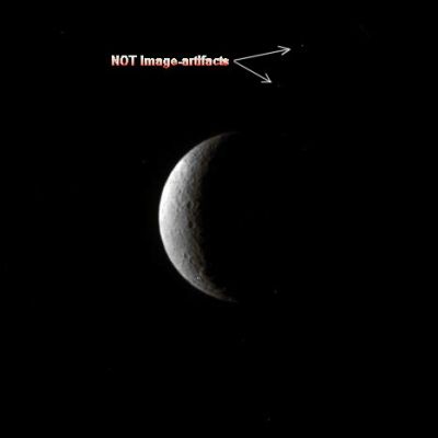 Rhea and two "Possible Companions"
Caption NASA:"A couple of craters share a crescent of Lit Terrain on Saturn's moon Rhea. 
Lit Terrain seen here is on the Trailing Hemisphere of Rhea. This view is centered on 48° North Latitude, 234° West Longitude. The North Pole is on the Terminator, about one-quarter of the way inward from the top of the image. 

The image was taken in Visible Violet Light with the Cassini Spacecraft narrow-angle camera on June 3, 2009. The view was obtained at a distance of approx. 1,4 MKM (such as about 870.000 miles) from Rhea and at a Sun-Rhea-Spacecraft, or Phase, Angle of 121°. 
Image scale is roughly 8 Km (about 5 miles) per pixel".
Parole chiave: Saturn's Moon - Rhea