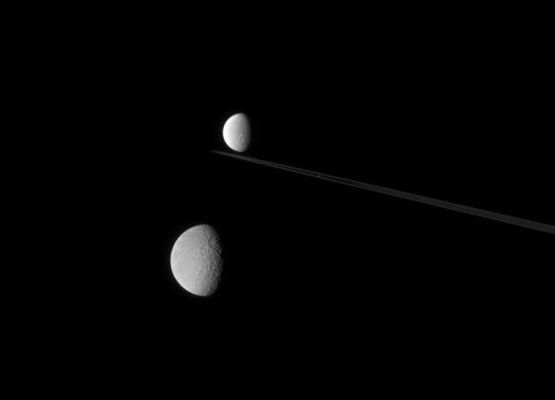 The "Crowded" Saturnian Sky
Caption NASA:"A string of icy moons stretches across the Saturn System in this view from nearly edge-on with the Ring-Plane. 
Nearest to the Cassini spacecraft is Rhea (1528 Km, or about 949 miles across) below center; then little Atlas (32 Km, or about 20 miles across), huddled close to the narrow F-Ring. Dione (1126 Km, or about 700 miles across) floats in the distance beyond. 

The image was taken in visible light with the Cassini spacecraft narrow-angle camera on July 8, 2007 at a distance of approx. 2,9 MKM (about 1,8 MMs) from Saturn. Image scale is roughly 14 Km (about 9 miles) per pixel on Rhea and 19 Km (about 12 miles) per pixel on Dione".
Parole chiave: Saturn's Moons - Dione, Rhea and Atlas