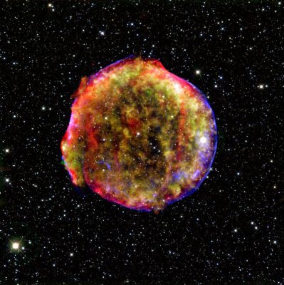Tycho: the most colourful Supernova Remnant
This composite image of the Tycho Supernova Remnant combines InfraRed and X-Ray observations obtained with NASA's Spitzer and Chandra space observatories, respectively, and the Calar Alto observatory, Spain. 
It shows the scene more than four centuries after the brilliant star explosion witnessed by Tycho Brahe and other astronomers of that era. 

The explosion has left a blazing hot cloud of expanding debris (green and yellow). The location of the blast's outer shock wave can be seen as a blue sphere of ultra-energetic electrons. Newly synthesized dust in the ejected material and heated pre-existing dust from the area around the supernova radiate at infrared wavelengths of 24 microns (red). 
Foreground and background stars in the image are white.
Parole chiave: From Space Images - Spitzer Space Telescope (SST) and Chandra Space Telescope (CST) Images