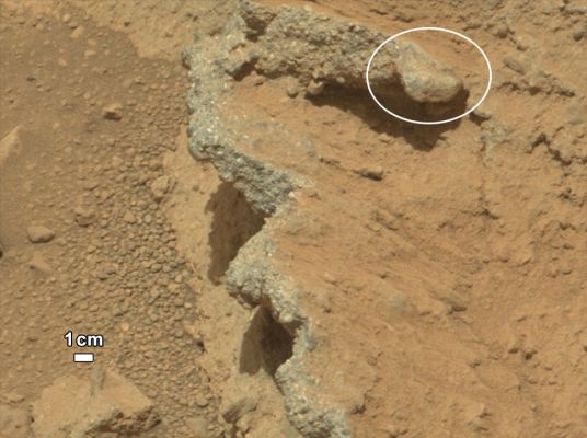 "Hard" Mars... - Sol 39 (Credits: NASA/JPL-Caltech/MSSS)
...Bisogna pure sorridere, in qualche modo ed in qualche misura...

Caption NASA:"NASA's Curiosity Rover found evidence for an ancient, flowing Stream on Mars at a few sites, including the Rock Outcrop pictured here, which the science team has named "Hottah" after Hottah Lake in Canada's Northwest Territories. It may look like a broken sidewalk, but this geological feature on Mars is actually exposed Bedrock made up of smaller fragments cemented together, or what geologists call a "Sedimentary Conglomerate". Scientists theorize that the Bedrock was disrupted in the past, giving it the titled angle, most likely via impacts from Meteorites. 
The key evidence for the ancient Stream comes from the size and rounded shape of the Gravel in and around the Bedrock. Hottah has pieces of gravel embedded in it, called clasts, up to a couple inches (few centimeters) in size and located within a matrix of sand-sized material. Some of the clasts are round in shape, leading the Science Team to conclude they were transported by a vigorous flow of Water. The Grains are too large to have been moved by Wind. A close-up view of Hottah reveals more details of the Outcrop. Broken surfaces of the Outcrop have rounded, Gravel Clasts, such as the one circled in white, which is about 1,2"  (3 centimeters) across. Erosion of the Outcrop results in Gravel Clasts that protrude from the Outcrop and ultimately fall onto the Ground, creating the Gravel Pile at left".
Parole chiave: Martian SUrface - Unusually-looking Rock - Gale Crater
