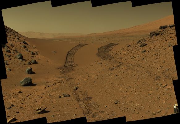 Looking Back - Sol 538 (Natural Colors - Credits: NASA)
This look back at a dune that NASA's Curiosity Mars rover drove across was taken by the rover's Mast Camera (MastCam) during the 538th Martian Day, or Sol, of Curiosity's work on Mars (Feb. 9, 2014). The Rover had driven over the dune three days earlier. For scale, the distance between the parallel wheel tracks is about 9 feet (i.e.: approx. 
2,7 meters). The dune is about 3 feet (a little more than 1 meter) tall in the middle of its span across an opening called "Dingo Gap". This view is looking Eastward. This raw color image was recorded by the camera under Martian lighting conditions. 
Parole chiave: Martian Surface and Sky