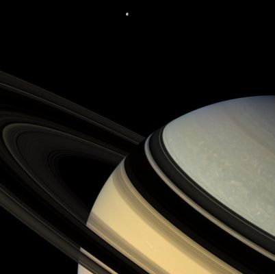 The Northern Regions of Saturn
Caption NASA:"Magnificent blue and gold Saturn floats obliquely as one of its gravity-bound companions, Dione, hangs in the distance. The darkened Rings seem to nearly touch their shadowy reverse images on the planet below. 
This view looks toward the unlit side of the Rings from about 9° above the Ring-Plane. The Rings glow feebly in the scattered light that filters through them. 

The image was taken in visible light with the Cassini spacecraft wide-angle camera on Feb. 4, 2007, at a distance of approx. 1,2 MKM (about 800.000 miles) from Saturn. 
Image scale is roughly 75 Km (about 47 miles) per pixel".
Parole chiave: Saturn