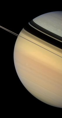 From North to South...
Caption NASA:"Dark and sharply defined ring shadows appear to constrict the flow of color from Saturn's warmly hued South to the bluish Northern Latitudes. 
Scientists studying Saturn are not yet sure about the precise cause of the color change from North to South. NASA Voyager spacecraft flybys witnessed a more evenly painted Planet in the early '80s, when Saturn was closer to Equinox. However, the bluish color was readily apparent upon Cassini's approach to the Planet in late 2003, when Saturn was just coming out of its Northern Hemisphere Winter. Scientists have speculated that the color is due to seasonal effects on the atmosphere. 
Aside from the color differences, the cloud morphology is quite different in the Polar Regions compared to the mid-latitudes. Bright, isolated clouds dot the high latitudes, while Saturn's middle is characterized by flowing cloud bands and the occasional bright or dark vortex. 
This view looks toward the lit side of the rings from about half a degree below the Ring-Plane.

Images taken using red, green and blue spectral filters were combined to create this natural-color view. The images were obtained with the Cassini spacecraft wide-angle camera on Feb. 4, 2007, at a distance of approx. 1,2 MKM (about 700.000 miles) from Saturn. Image scale is roughly 67 Km (about 42 miles) per pixel". 
Parole chiave: Saturn