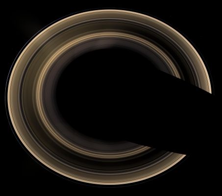 The Ring-World in natural colors
Caption NASA:"Our robotic emissary, flying high above Saturn, captured this view of an alien copper-colored Ring-World. The overexposed planet has deliberately been removed to show the unlit Rings alone, seen from an elevation of 60°, the highest Cassini has yet attained. 
The view is a mosaic of 27 images -- nine separate sets of red, green and blue images -- taken over the course of about 45', as Cassini scanned across the entire main Ring System. The Planet's shadow carves a dark swath across the Ring-Plane at the right. 

Moons visible in this image: Epimetheus, at the 1 o'clock position; Pandora, at the 5 o'clock position and Janus, at the 10 o'clock position. 

Bright clumps of material in the narrow F-Ring moved in their orbits between each of the color exposures, creating a chromatic misalignment that provides some sense of the continuous motion in the Ring System. 
Radially extending lens flare artifacts, which result from light being scattered within the camera optics, are present in the view. 

The images in this natural-color view were obtained with the Cassini spacecraft wide-angle camera on Jan. 21, 2007, at a distance of approx. 1,6 MKM (1 MMs) from Saturn. Image scale is 90 roughly Km (about 56 miles) per pixel". 


Parole chiave: Saturn