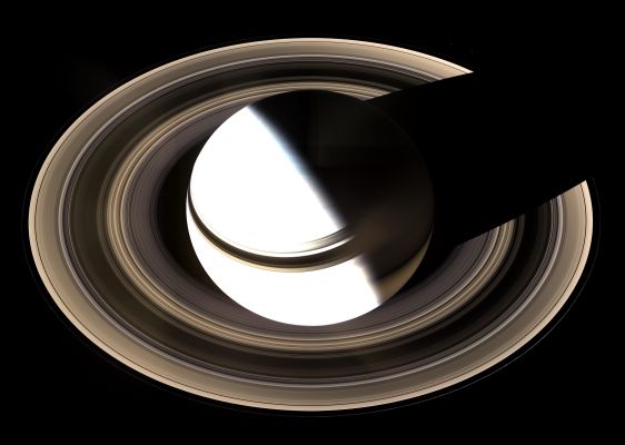 The Ringed World, from above
Caption NASA:"Surely one of the most gorgeous sights the Solar System has to offer, Saturn sits enveloped by the full splendor of its stately Rings. Taking in the Rings in their entirety was the focus of this particular imaging sequence. Therefore, the camera exposure times were just right to capture the dark-side of its Rings, but longer than that required to properly expose the globe of sunlit Saturn. Consequently, the sunlit half of the Planet is overexposed. 
Between the blinding light of day and the dark of night, there is a strip of twilight on the globe where colorful details in the atmosphere can be seen. Bright clouds dot the bluish-grey Northern Polar Region here. In the South, the Planet's night side glows golden in reflected light from the Rings' sunlit face. 
Saturn's shadow stretches completely across the Rings in this view, taken on Jan. 19, 2007, in contrast to what Cassini saw when it arrived in 2004. 

The view is a mosaic of 36 images -- that is, 12 separate sets of red, green and blue images -- taken over the course of about 2,5 hours, as Cassini scanned across the entire Main Ring System. This view looks toward the unlit side of the Rings from about 40° above the Ring-Plane. 

The images in this natural-color view were obtained with the Cassini spacecraft wide-angle camera at a distance of approx. 1,23 MKM (about 764.000 miles) from Saturn. Image scale is roughly 70 Km (about 44 miles) per pixel".
Parole chiave: Saturn