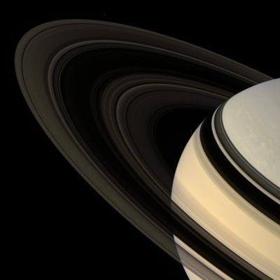 Saturn (natural colors - elab. NASA)
Caption NASA:"Colorful Saturn tilts its darkened Ring-Plane toward Cassini. Against the dark sky, the Rings are made visible by the light that scatters through them toward the camera. 
The F-Ring shepherd moon Pandora is faintly visible at the top, left of center. Pandora's brightness was increased by a factor of three to aid its visibility. 
This view looks toward the unilluminated side of the Rings from about 18° above the Ring-Plane. The Planet is visible through the innermost and outermost portions of the Rings. 
Images taken using red, green and blue spectral filters were combined to create this natural color view. The images were obtained by the Cassini spacecraft wide-angle camera on April 13, 2007, at a distance of approx. 1,8 MKM (about 1,1 MMs) from Saturn. 
Image scale is roughly 108 Km (about 67 miles) per pixel".
Parole chiave: Saturn