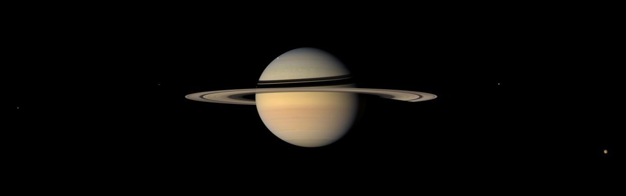 A View from Japetus
While on final approach for its Sept. 2007 close encounter with Saturn's moon Japetus, Cassini spun around to take in a sweeping view of the Saturn System. 
Japetus is the only major moon of Saturn with a significant inclination to its orbit. From the other major satellites, the Rings would appear nearly edge-on, but from Japetus, the Rings usually appear at a tilt, as seen here.
This natural color mosaic consists of 15 red, green and blue spectral filter images acquired in five wide-angle camera footprints that swept across the scene.

Moons visible in this image: Dione at center left, Enceladus near the left side ansa (or ring edge), Mimas is a speck against the ring shadows on Saturn's Western Limb, Rhea can be seen against the bluish backdrop of the Northern Hemisphere, Tethys is near the right ansa, and Titan near lower right.

The images were obtained on Sept. 10, 2007, at a distance of approx. 3,3 MKM (such as about 2,1 MMs) from Saturn at a Sun-Saturn-Spacecraft, or phase, angle of 33°. Image scale is about 195 Km (approx. 121 miles) per pixel on the Planet. 
Parole chiave: Saturn