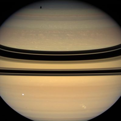 Electrical Storm on Saturn's Upper Troposphere (natural colors; credits: NASA)
Caption NASA:"A bright, powerful, lightning-producing storm churns and coasts along the lane of Saturn's Southern Hemisphere nicknamed "Storm Alley" by scientists. 
NASA's Cassini spacecraft detected this particular tempest after nearly 2 years during which Saturn did not appear to produce any large electrical storms of this kind. The storm appears as a bright, irregular splotch on the Planet near lower right. 

Lightning flashes within the persistent storm produce radio waves, called Saturn Electrostatic Discharges, which the Cassini radio and plasma wave science instrument first detected on Nov. 27, 2007. Cassini's imaging cameras then spotted the storm, taking the images used to create this color view about a week later on Dec. 6, 2007. 

This electrical storm is similar in appearance and intensity to those previously monitored by Cassini. All of these powerful electrostatic producing storms appeared at about 35° South Latitude on Saturn.
This storm has now been continuously tracked by Cassini for several months, whereas previous storms observed by the Spacecraft lasted for less than 30 days. 

The view looks toward the un-illuminated side of the Rings from about 5° above the Ring-Plane. Tethys (about 1071 Km, or approx. 665 miles across) is seen here in the foreground, and casts its shadow onto the high Northern Latitudes. 
Images taken using red, green and blue spectral filters were combined to create this natural color view. The images were acquired with the Cassini spacecraft wide-angle camera at a distance of approx. 1,7 MKM (1 MMs) from Saturn. 
Image scale is roughly 97 Km (about 60 miles) per pixel".
Parole chiave: Saturn