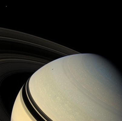 Perspectives... (natural colors; credits: NASA)
Caption NASA:"The Ringed Planet sits in repose, the center of its own macrocosm of many rings and moons and one artificial satellite named Cassini. Mimas (approx. 397 Km, or about 247 miles across) is visible at upper left. Although unseen in this view, Enceladus (approx. 504 Km, or about 313 miles across) casts its shadow upon the Planet. The Rings also block the Sun's light from the low Latitudes of the Northern Hemisphere. 

During Cassini's extended mission, dubbed the Cassini Equinox Mission, which begins on July 1, 2008, the Ring shadows will slip past the Planet's Equator and into the Southern Hemisphere as Saturn passes through its Northern Vernal Equinox on August 11, 2009, and the Sun moves northward through the Ring-Plane. 

This view looks down on the unilluminated side of the Rings, from about 22° above (such as North of) the Ring-Plane. Images taken using red, green and blue spectral filters were combined to create this natural color view. The images were obtained with the Cassini Spacecraft wide-angle camera on Dec. 16, 2007, at a distance of approx. 1,4 MKM (such as about 900,000 miles) from Saturn. 
Image scale is roughly 86 Km (about 53 miles) per pixel".
Parole chiave: Saturn