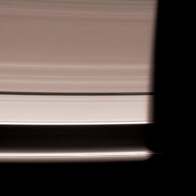 Vanishing Pan... (Natural Colors; credits: NASA/JPL/Space Science Institute)
Caption NASA originale:"The Cassini spacecraft looks down at the unlit side of the Rings as Pan heads into Saturn's shadow. The moon is accompanied by faint ringlets in the Encke Gap. At bottom, the bright F-Ring core fades slowly into darkness. This view looks toward the unlit side of the Rings from about 20° above the Ring-Plane. 

The image was taken in visible light with the Cassini spacecraft wide-angle camera on Nov. 15, 2006. Cassini was then at a distance of approx. 1,7 MKM (about 1,1 MMs) from Saturn and at a Sun-Saturn-Spacecraft, or Phase, Angle of 163°. Image scale is roughly 10 Km (approx. 6 miles) per pixel".
Parole chiave: Saturn