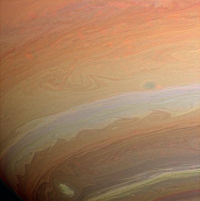 The Upper Atmosphere of Saturn
Caption NASA:"Whorls, streamers and eddies play in the banded atmosphere of a Gas Giant. Strong image enhancement renders unto Saturn's clouds a grainy texture not unlike sandstone. However, the loss in delicate smoothness is compensated for by an increase in discernible detail. 

The image was taken with the Cassini Spacecraft wide-angle camera using a combination of spectral filters sensitive to wavelengths of infrared light centered at 728 (green channel), 752 (red channel) and 890 (blue channel) nanometers. The semi-transparent red features across the image are clouds detected by the 752 nanometer filter. The view was acquired on Aug. 19, 2005 at a distance of approx. 492.000 Km (such as about 306.000 miles) from Saturn. Image scale is roughly 26 Km (about 16 miles) per pixel".
Parole chiave: Saturn - Upper Atmosphere