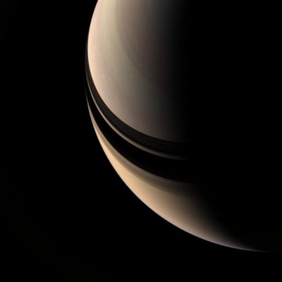 A Planetary "Smile", from Saturn...
Caption NASA:"Brooding Saturn seems to be missing its rings, but their shadows on the Planet betray their presence. The inner rings are in fact contained within this scene, but they are so tenuous as to be nearly invisible. 
This view looks toward the unilluminated side of the Rings from about 52° above the Ring-Plane. Some motion is apparent in Saturn's clouds between the exposures used to create this color composite, as evidenced by the 'rainbow' effect seen here and there across the face of the Planet. 

Images taken using red, green and blue spectral filters were combined to create this natural color view. The images were taken with the Cassini spacecraft wide-angle camera on April 5, 2007 at a distance of approx. 1,5 MKM (about 900.000 miles) from Saturn. 
Image scale is roughly 84 Km (about 52 miles) per pixel".
Parole chiave: Saturn