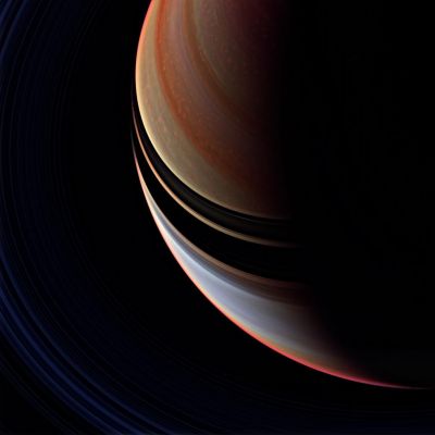 Candy Stripes
Caption NASA:"This strongly enhanced false color view is a departure from the familiar bluish North and golden South seen in natural color Cassini spacecraft images, but the contrast between regions north and South of the Ring shadows is here more readily apparent. 
The Northern Region is marked by a multitude of bright, patchy clouds. 
The Region south of the Ring shadows contains the bright equatorial band seen in many monochrome Cassini views taken at infrared wavelengths (see PIA07590). 

Taken just minutes after PIA08936, this view makes Saturn's Rings faintly visible at lower left. The false color enhancement brings out additional detail in the Planet's clouds that is not visible in the natural color view. 

This view looks toward the unilluminated side of the Rings from about 52° above the Ring-Plane".
Parole chiave: Saturn