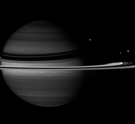 Obscure Planet, Bright Moons... (IR)
Caption NASA:"Just before Rhea slipped behind Saturn, the Cassini Spacecraft captured the moon in its disappearing act. 
Along with the partly obscured Rhea are Tethys, at right, and Enceladus, left of Tethys. 
At the wavelength in which this image was taken, absorption of Sunlight by Methane gas in Saturn's Atmosphere is strong, causing the Planet to appear darker than at other wavelengths. 

This view looks toward the unilluminated side of the Rings from about 4° above the Ring-Plane. The image was taken with the Cassini spacecraft wide-angle camera on Nov. 9, 2007 using a spectral filter sensitive to wavelengths of Infrared Light centered at 890 nanometers. The view was acquired at a distance of approx. 2,8 MKM (about 1,7 MMs) from Saturn and at a Sun-Saturn-spacecraft, or phase, angle of 44°. 
Image scale is roughly162 Km (such as about 101 miles) per pixel".
Parole chiave: Saturn and Companions